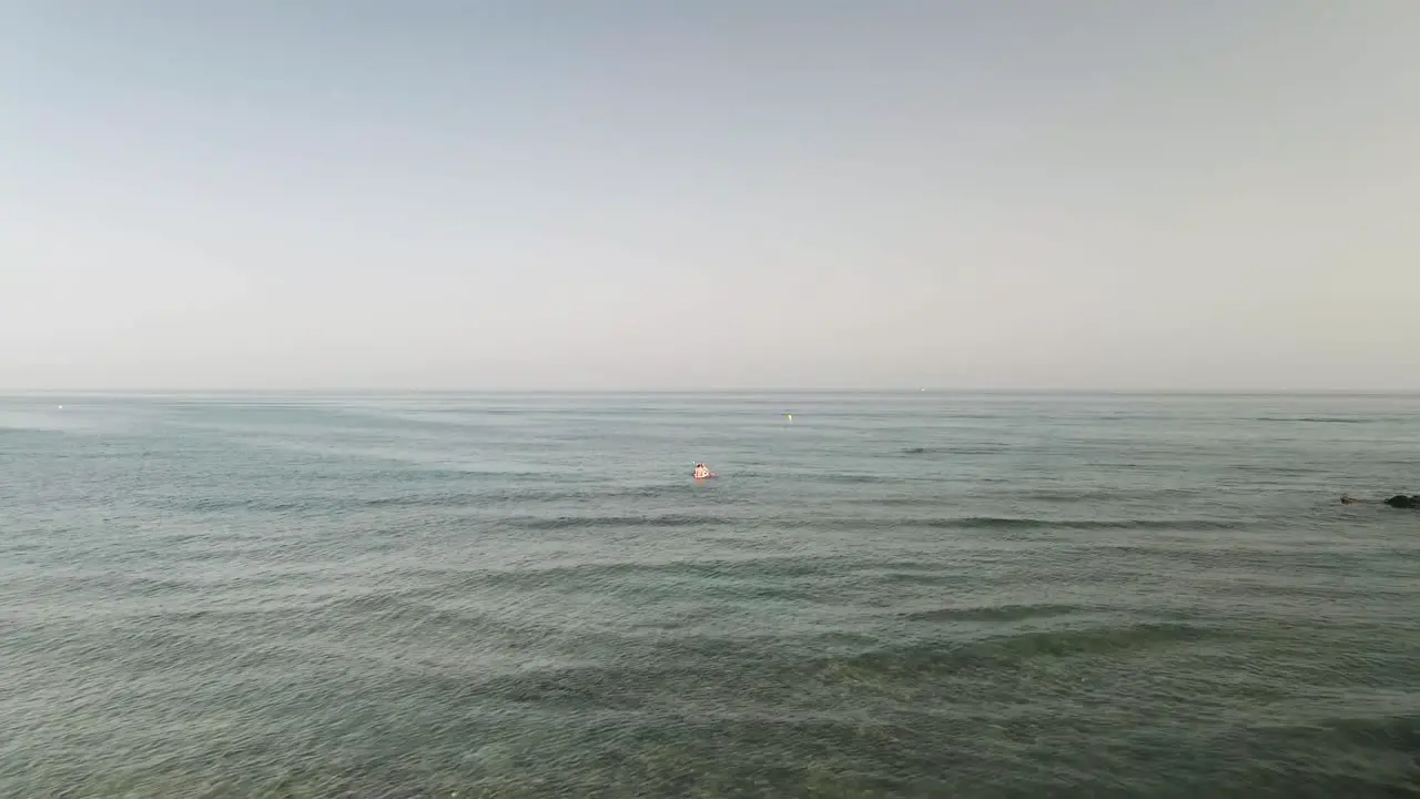 Aerial dolly with people kayaking on the sea