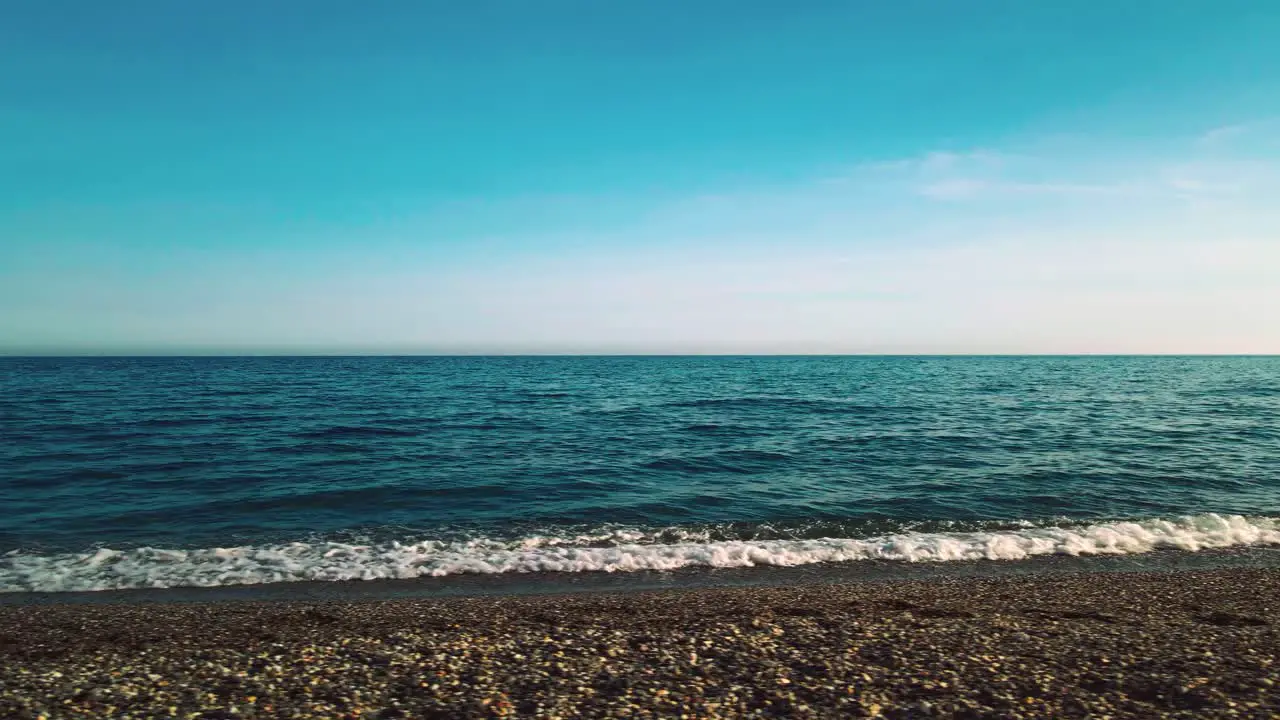 Moving alongside the empty beach on a clear day