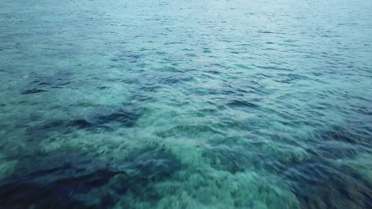 AERIAL 4K Slow Pan Over Crystal Indonesian Beach Ocean