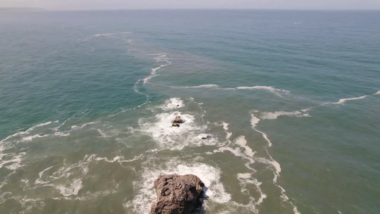 Aerial flyback ascending over Nazare lighthouse Portugal