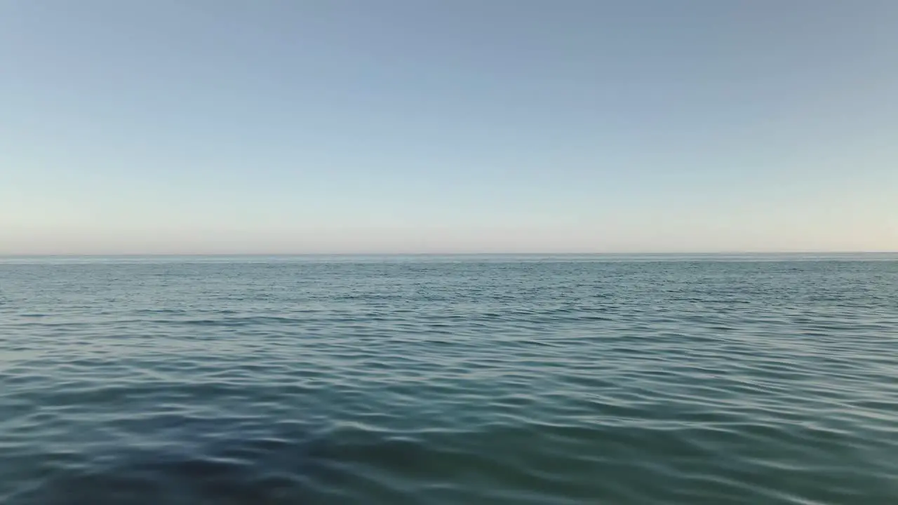 Vast huge open ocean seascape blue water calm wave surface looking out to horizon