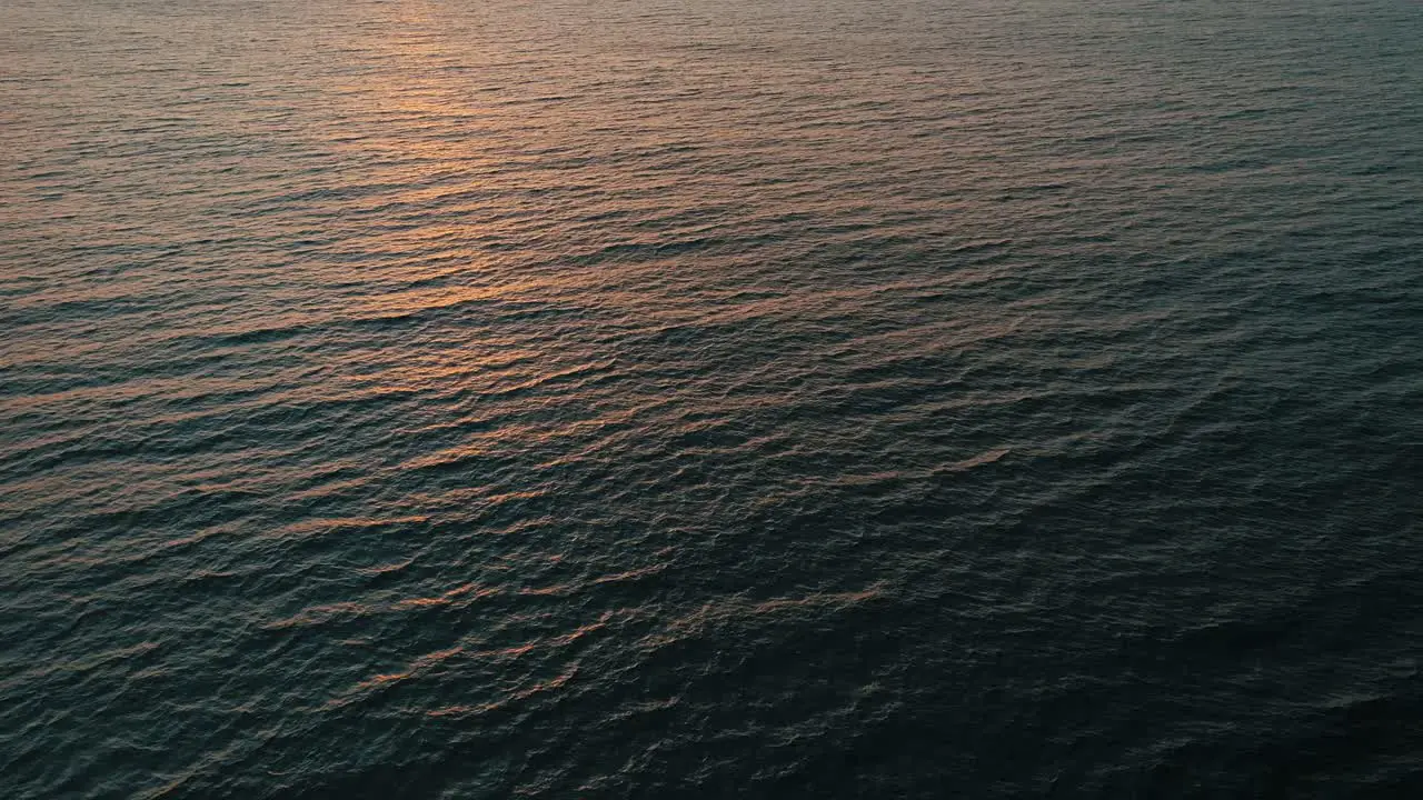 Reflection of sunrise in the ocean aerial view