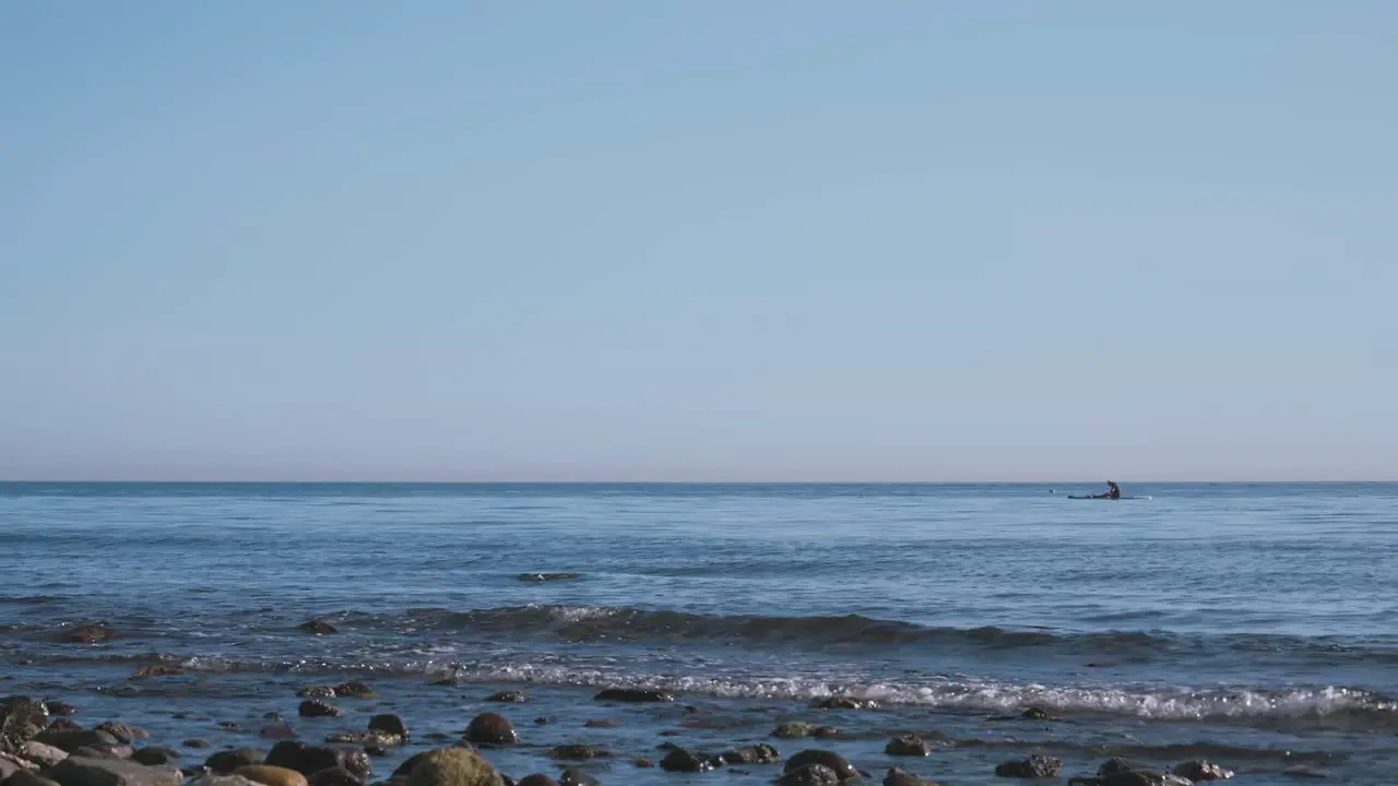 120FPS Sped up footage of beach with man on a paddling board at the distance