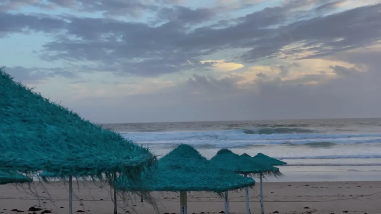 View of the beautiful beach scene with the sea on the horizon and a wind umbrella on the sand in winter travel vacation and tropical tourist destination concept