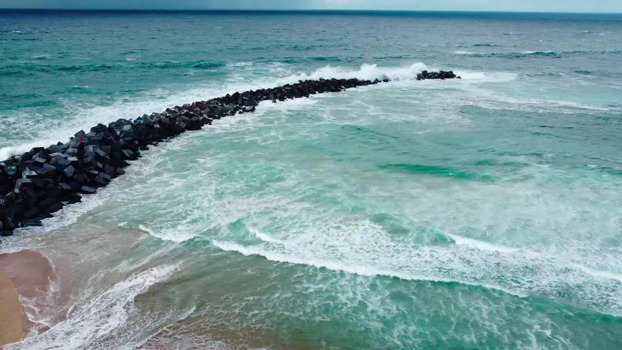 Coastal protection in San Sebastian with big waves colliding with a rockfill sea dike