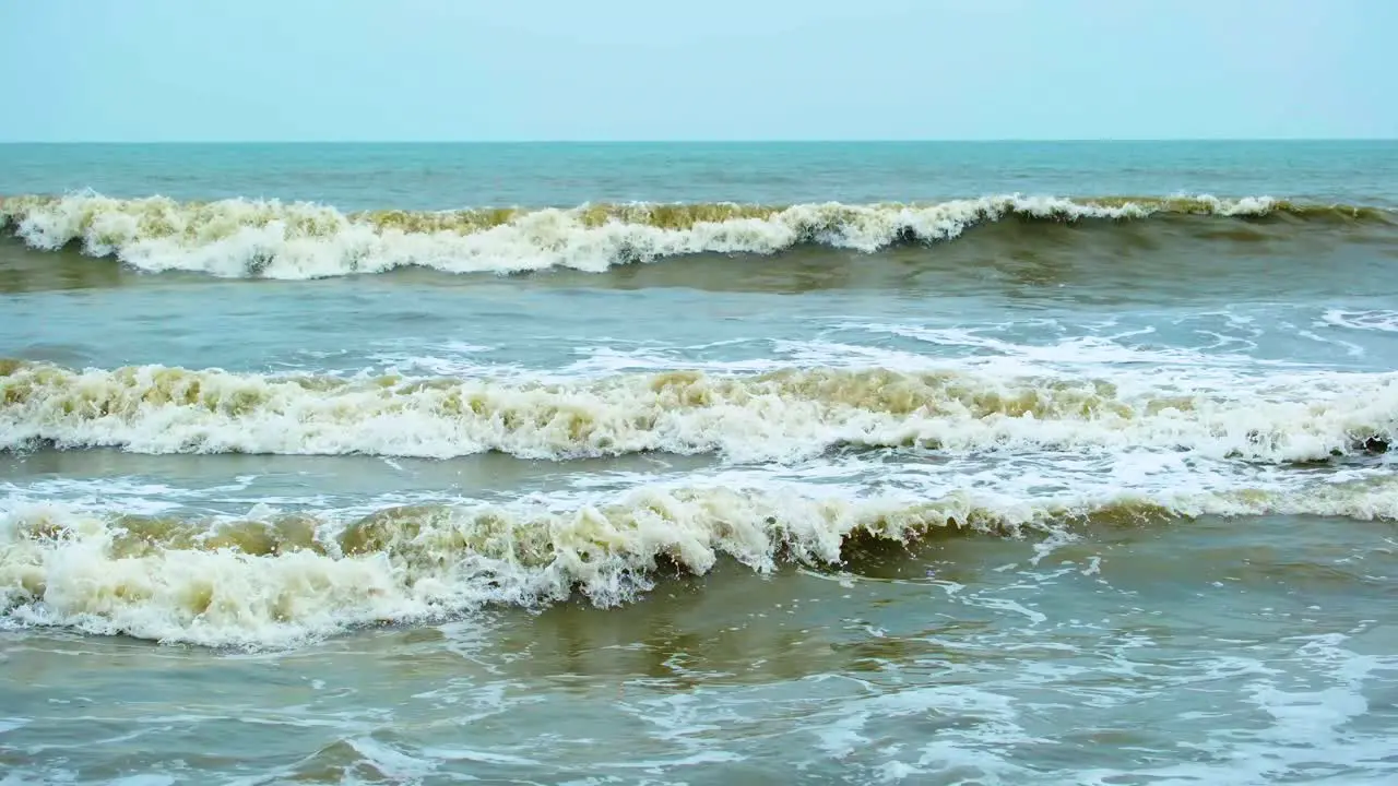 Slow motion clip of waves in the sea seen from the beach