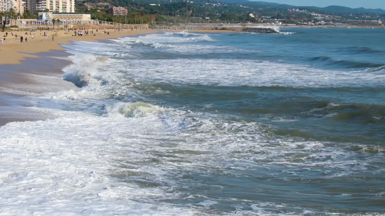 Waves crashing on the shore of the beach on a sunny morning