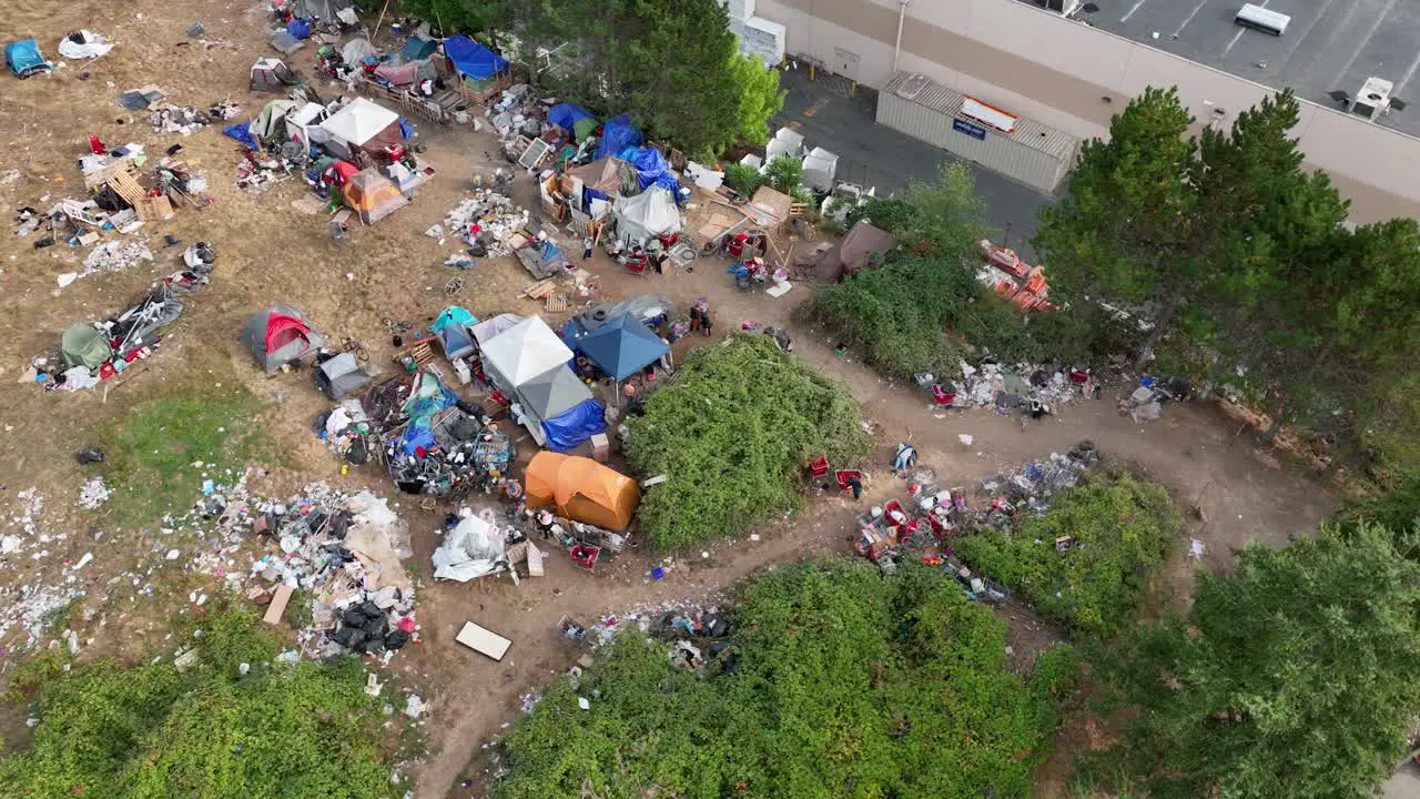 Overhead drone shot of a homeless camp in Washington State with trash spread across the ground