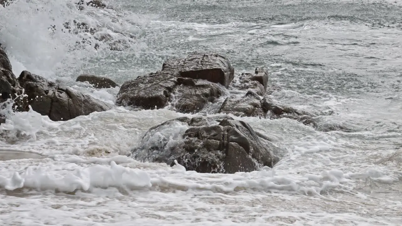 Ocean Waves Crashing Against Rocks And Cliffs On Beach In Bai Bang Con Dao Vietnam