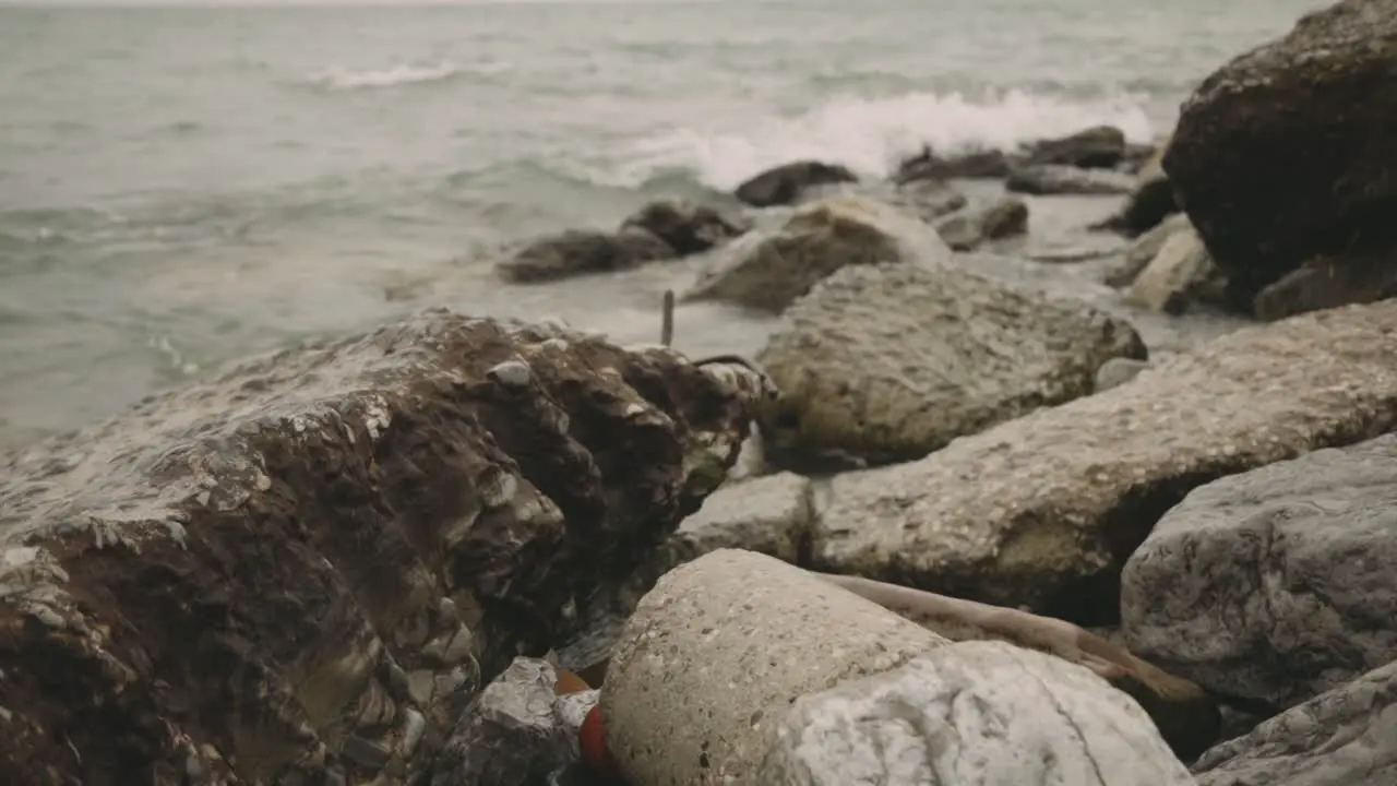 Large Rocks On The Shore With Splashing Waves During Daytime