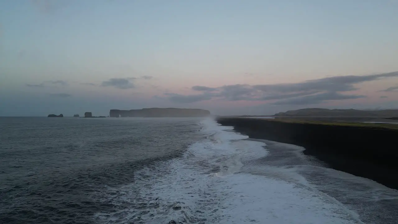 Sunrise looking toward cliffs in Reynisfjara in Iceland aerial