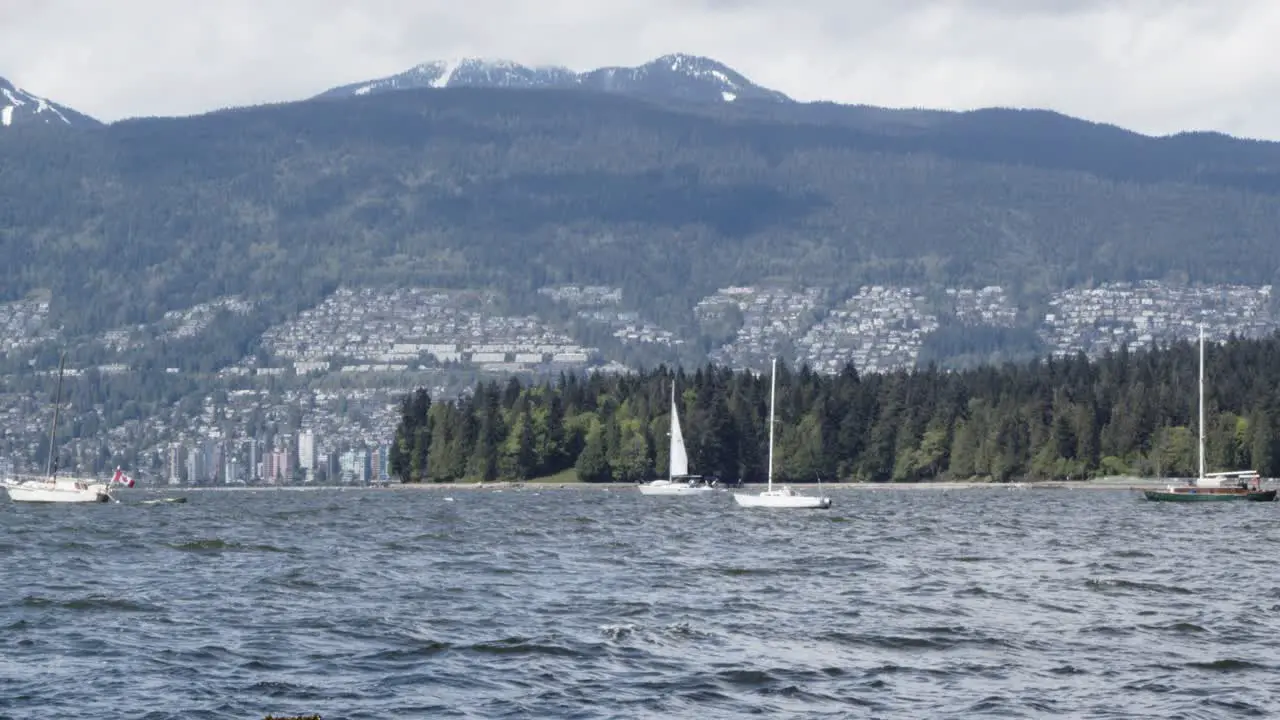 Waves passing vancouver False Creek inlet stanley park west vancouver and sail boats