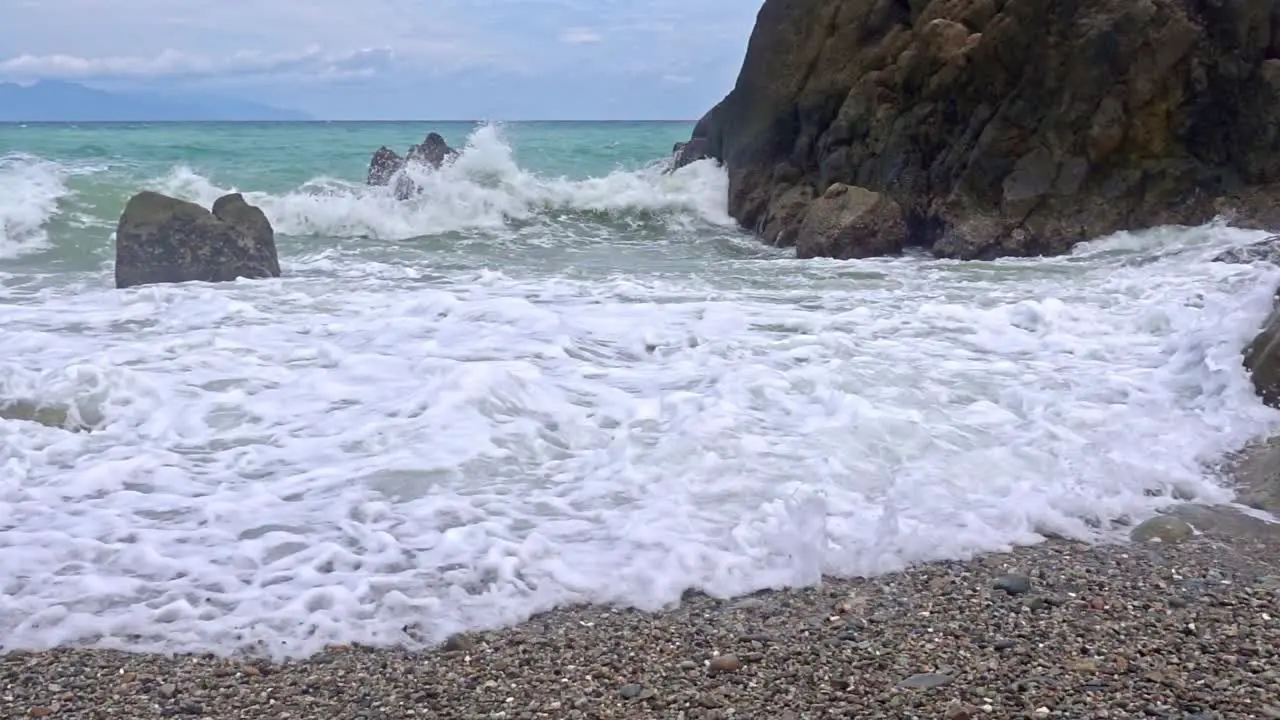 Slow-motion view of waves splashing against rocks in Banbanon Beach in Surigao del Norte in the Philippines