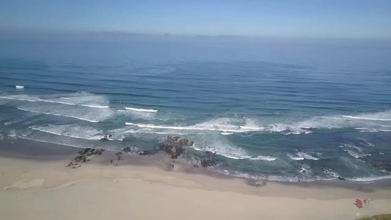 Top down aerial view of perfect ocean waves crashing and foaming