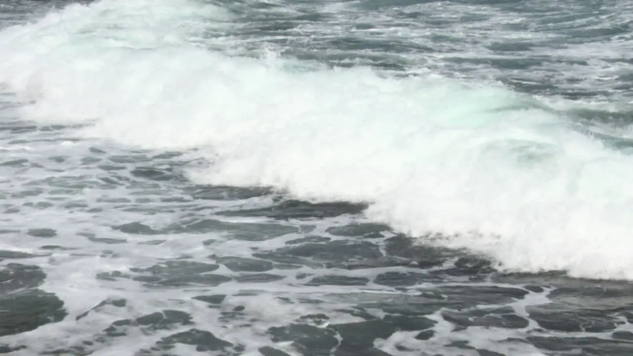 Waves breaking rolling on land Bonaire