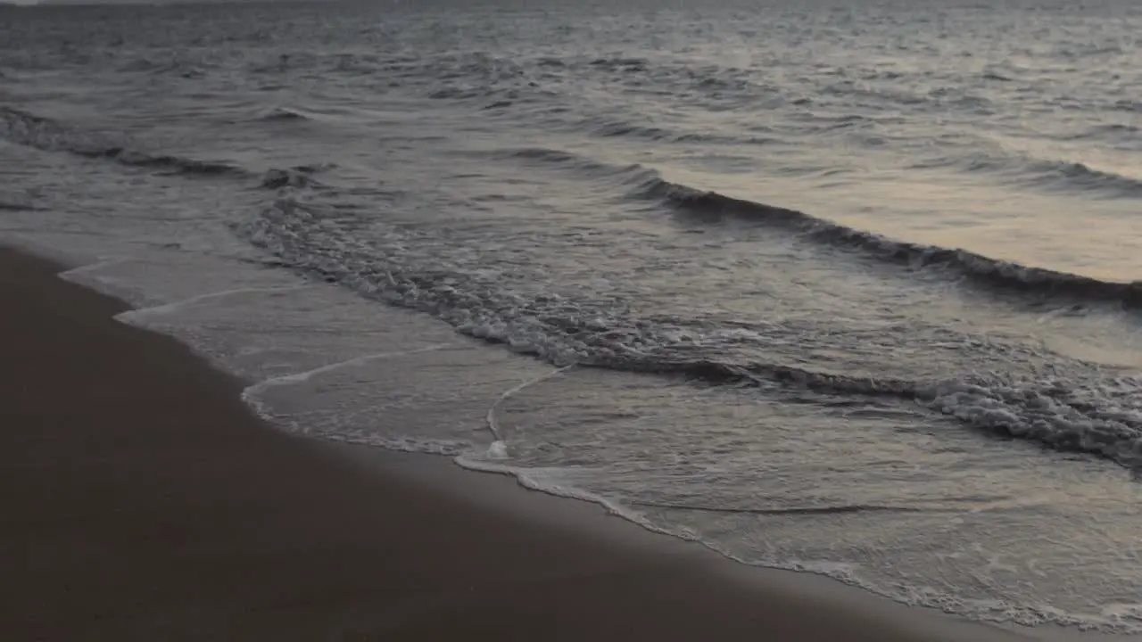 Waves crashing along the shore at dusk in Maui Hawaii