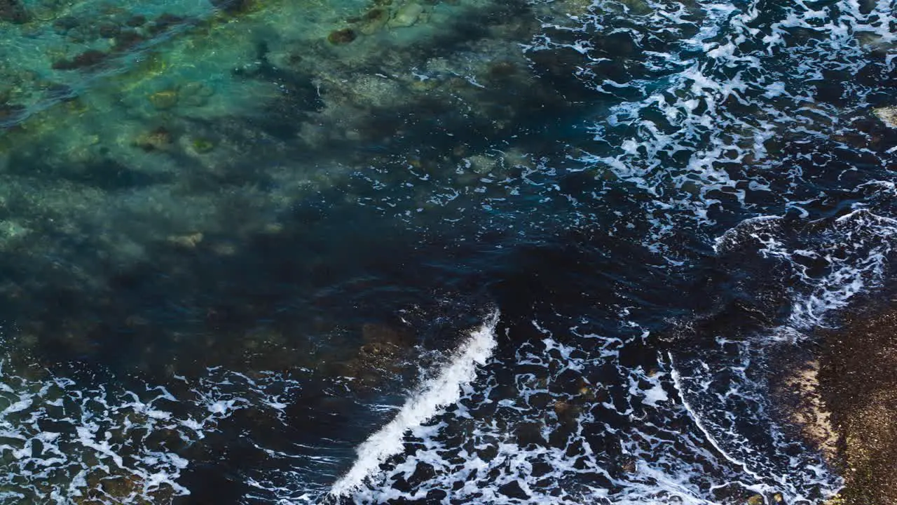 Dirty sea pattern with algae under water waving and foaming on sandy beach in Mediterranean coastline