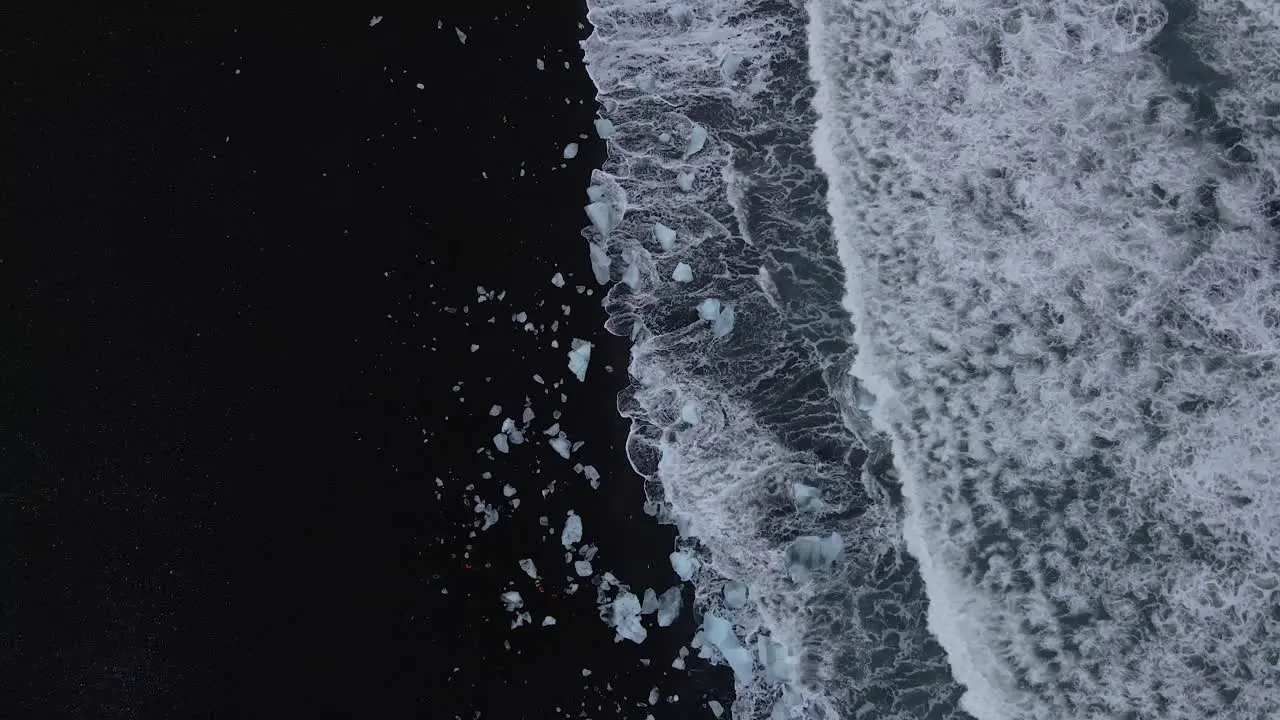 Waves breaking on black sandy lagoon at Diamond beach Iceland