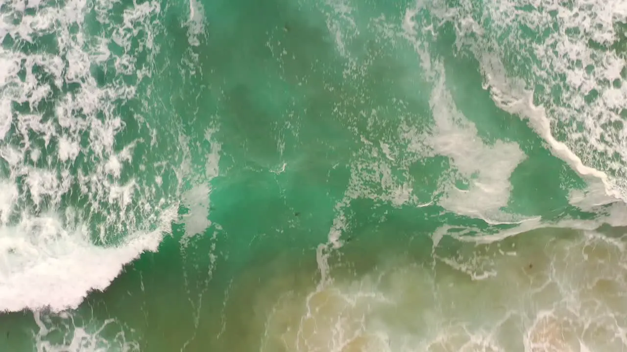 Slow Motion Of Foamy Sea Waves Running Onto The Shore With Golden Sand