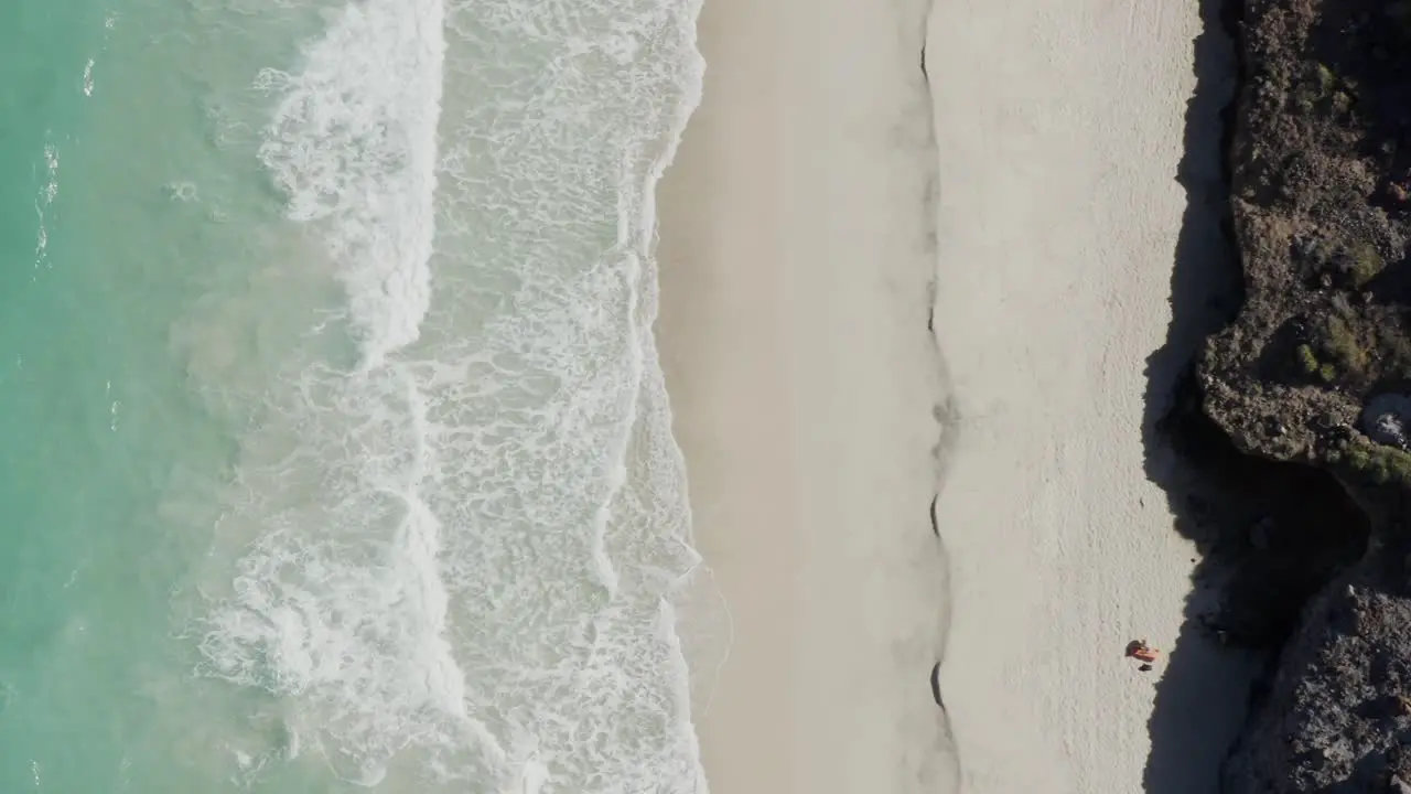 Top-down of Sunbather laying on Tecolote Beach Baja Mexico