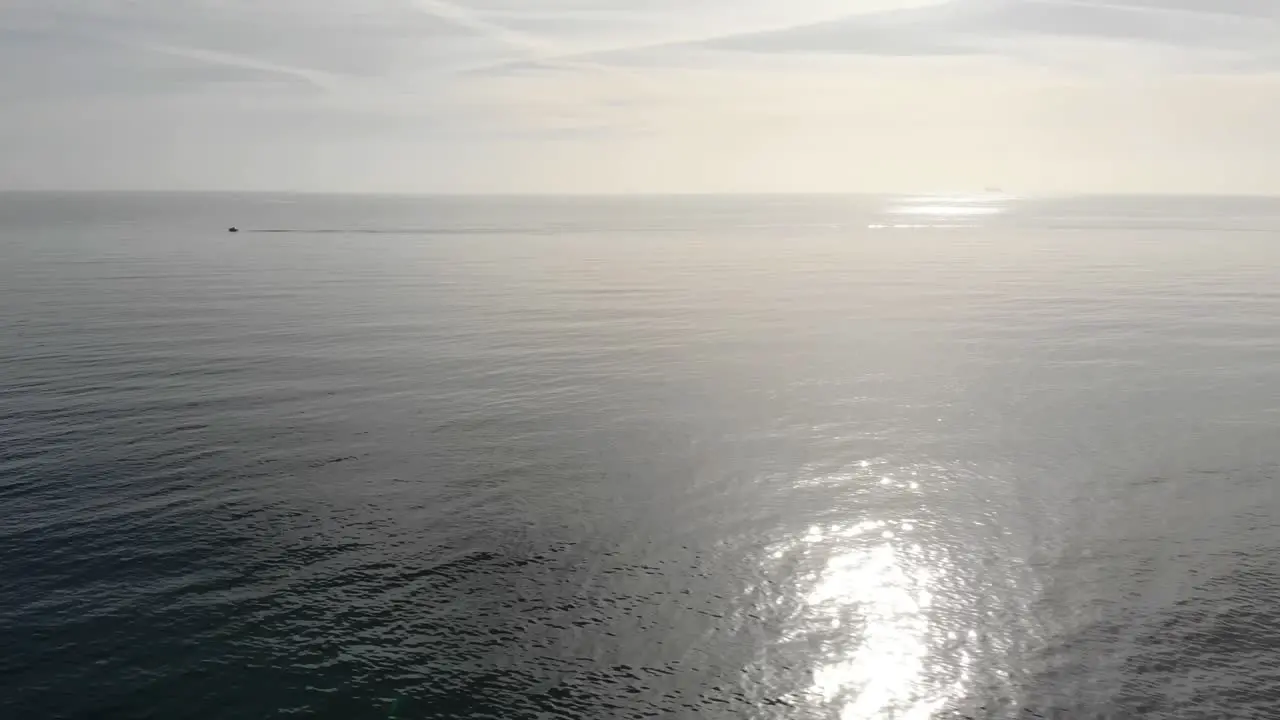 Aerial Over Calm Sea Waters With Light From Sun Reflected On Surface