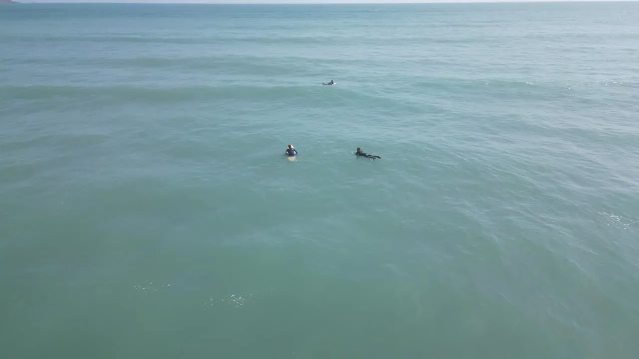 Aerial spinning shot of surfers in the sea