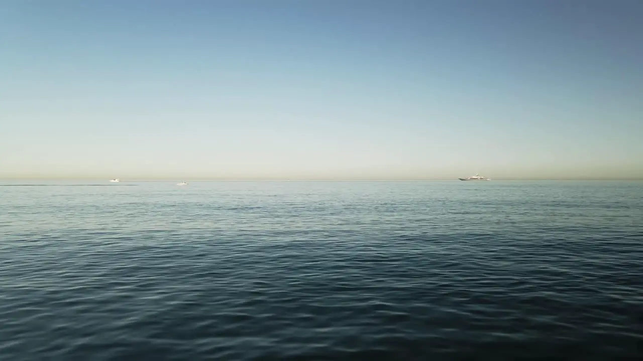 Forward view over the water with jet ski passing far away