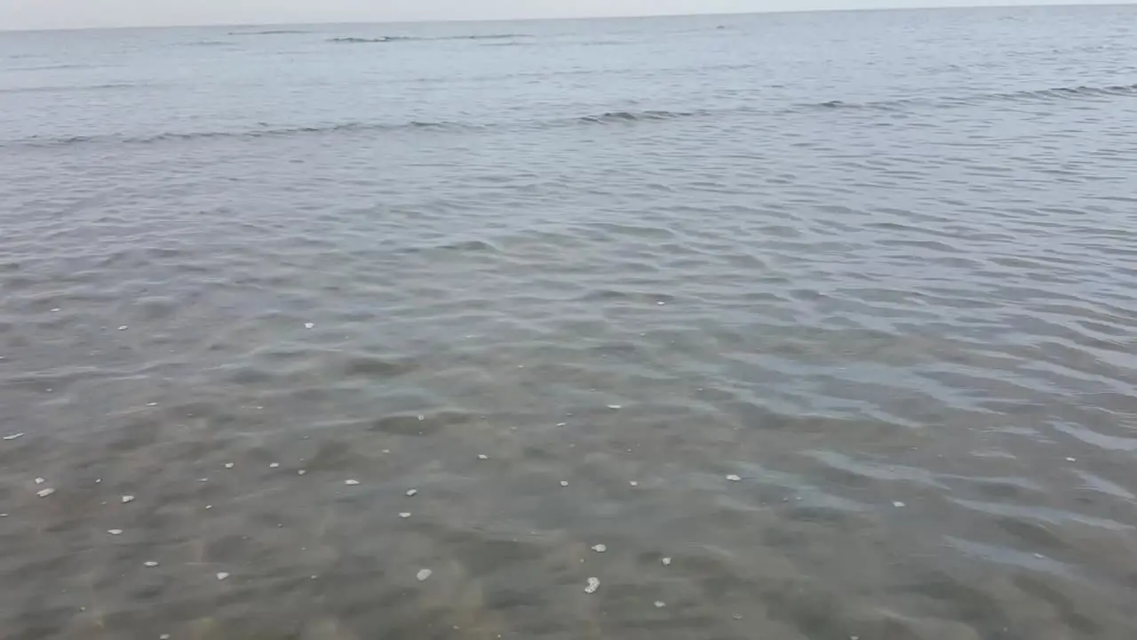 The surface of the water waves at the beach