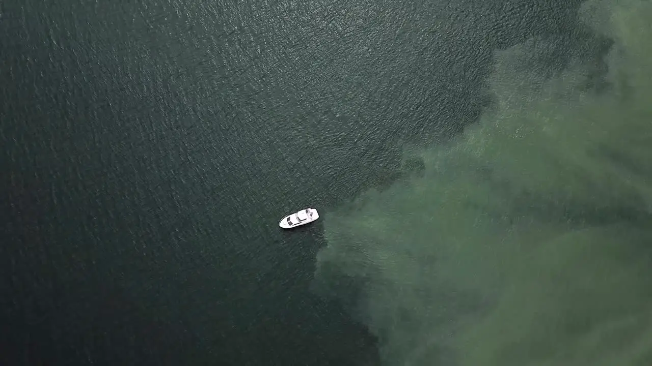 Yacht Sailing Over The Shallow Blue Sea In Tacoma Washington During Low Tide top view slowmo