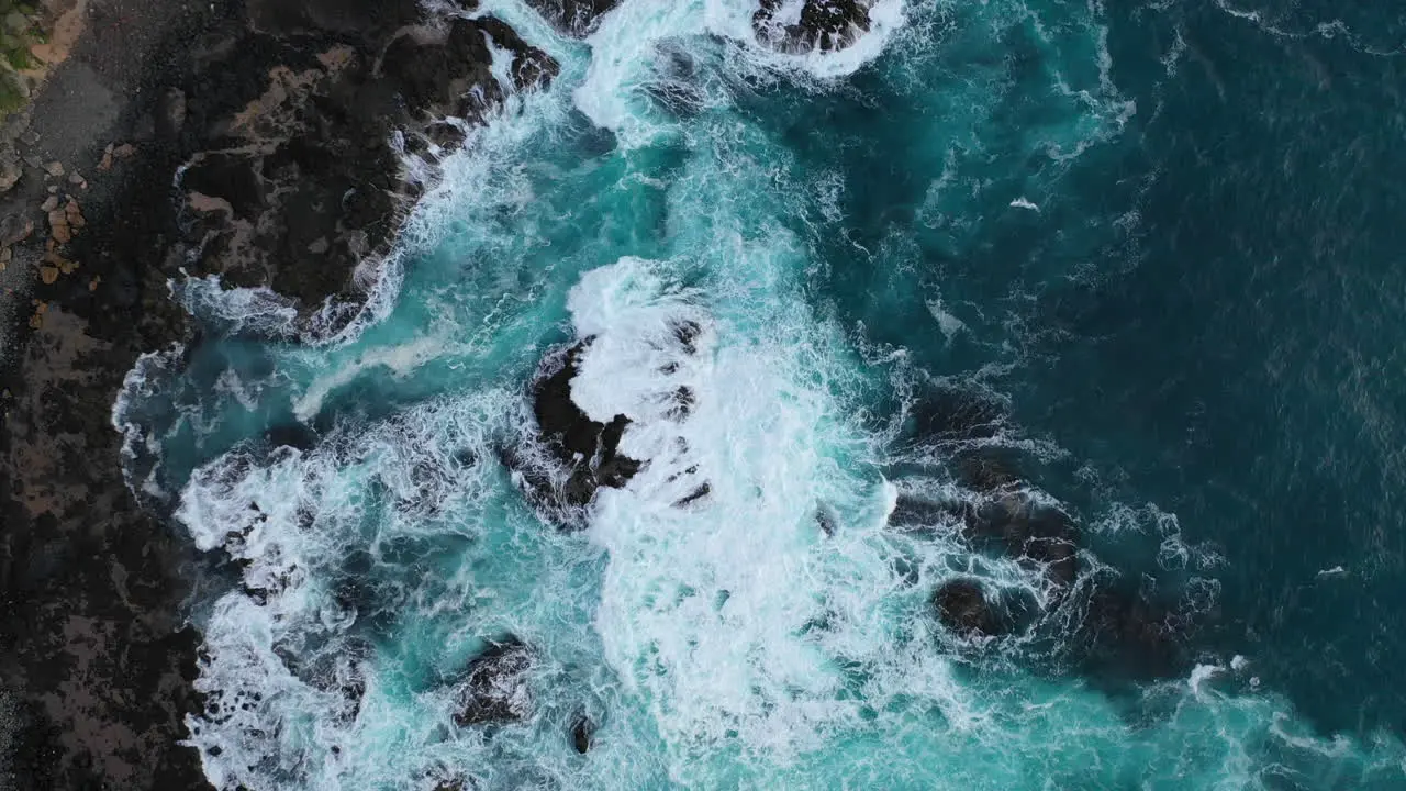 Flight over a dramatic coastline as waves crash against a rocky shore