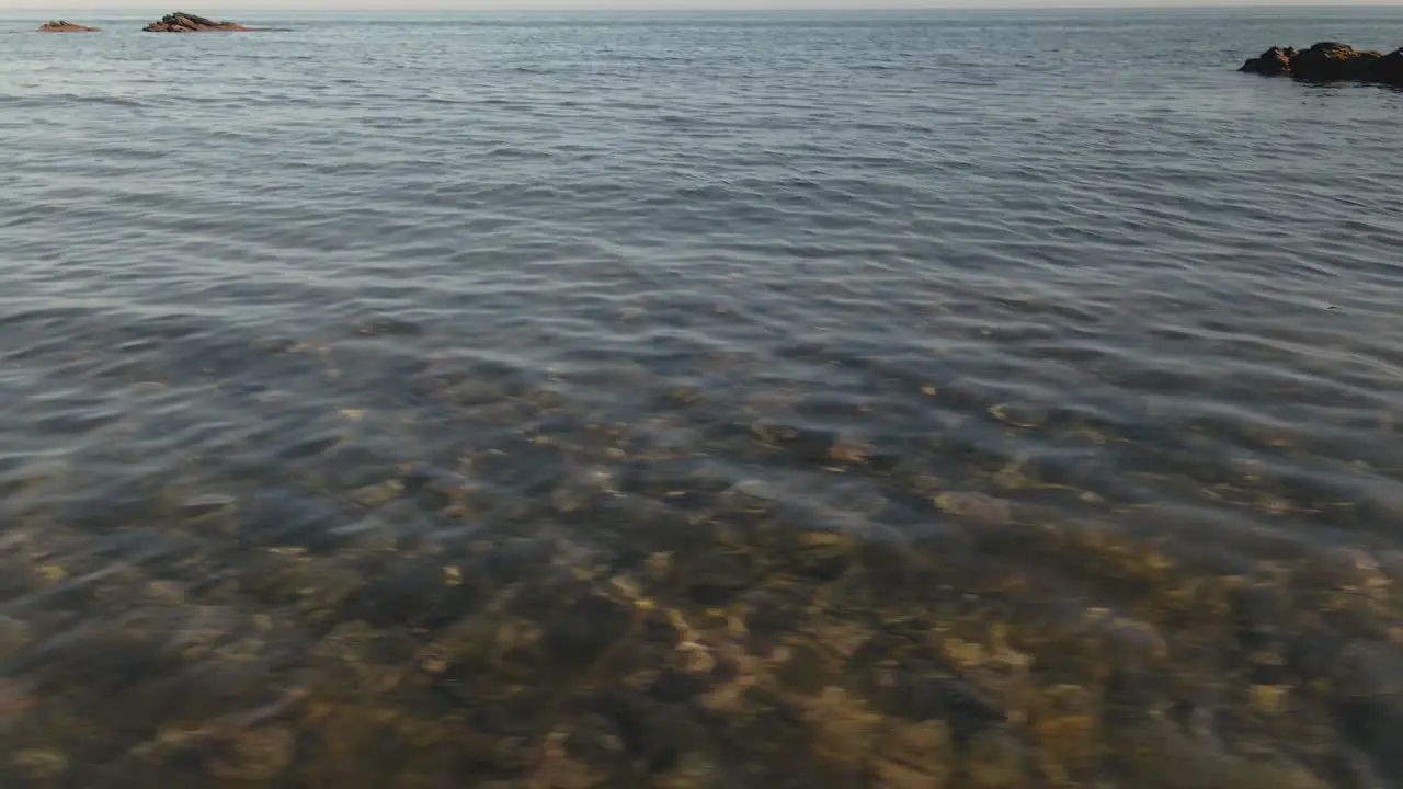 Clear transparent holiday ocean seascape tilt up to beautiful Spanish horizon dolly left