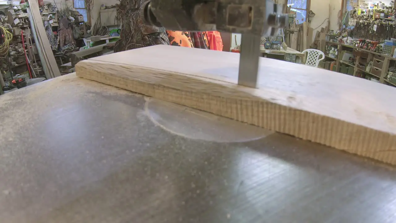 Using a bandsaw to cut a board