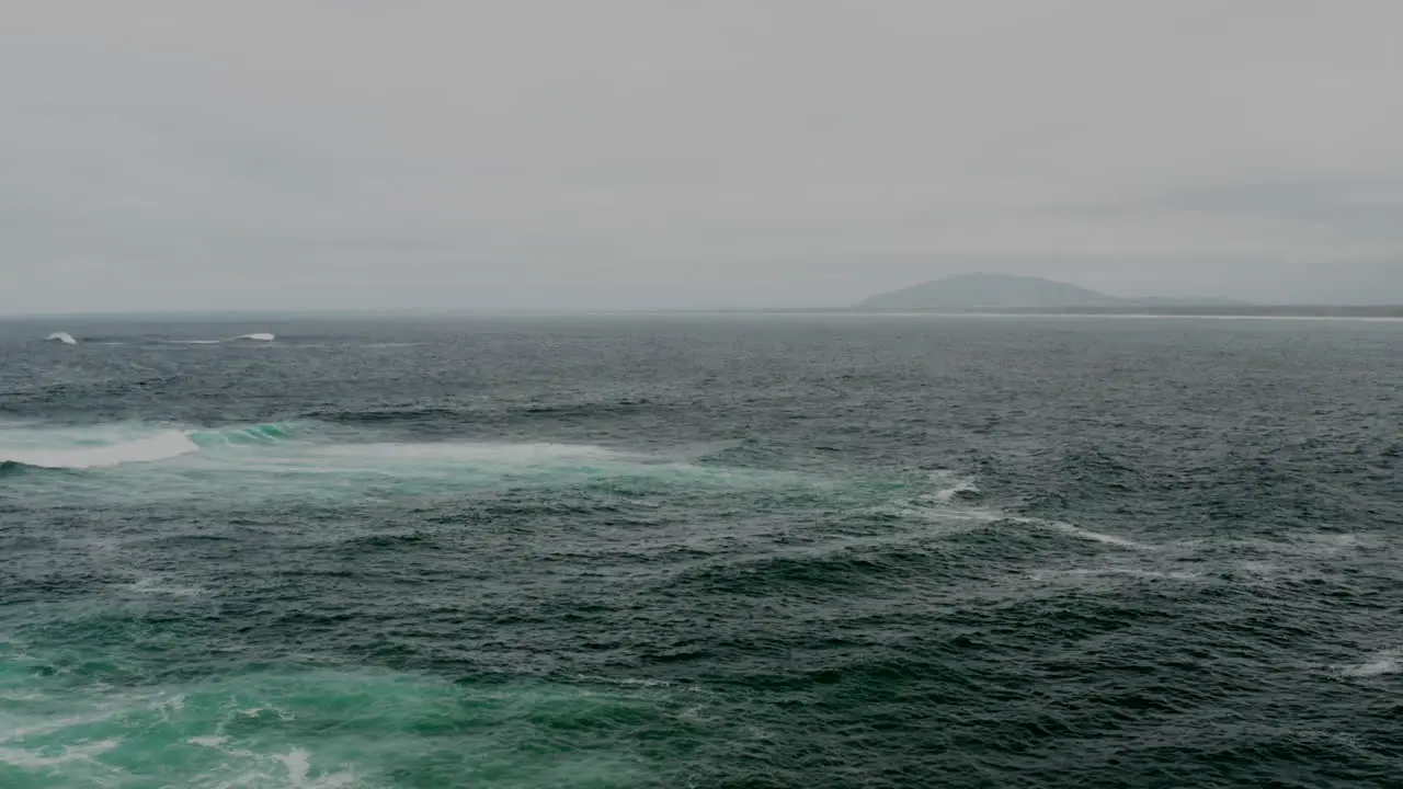 Aerial drone flying over a stormy ocean off the south coast of NSW Australia