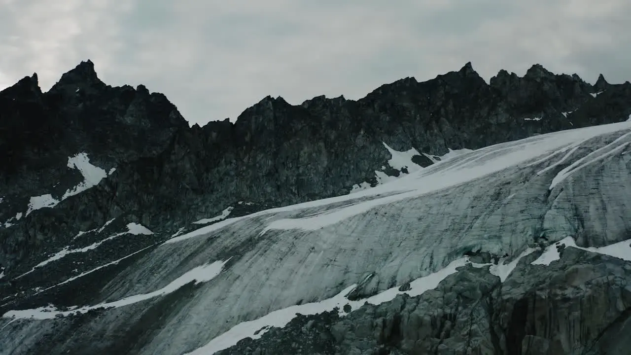 Alaskan Rugged Mountain Range Drone Flying through the Clouds and Mountains at Sunrise