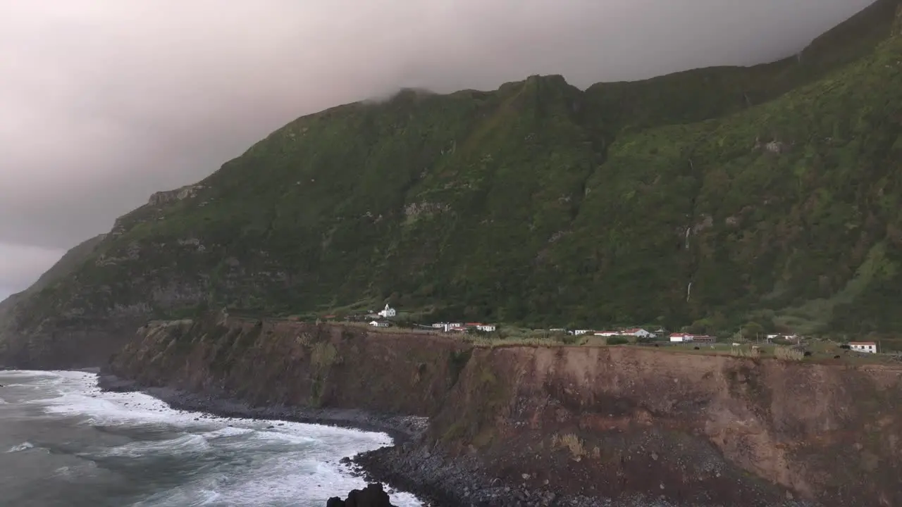 Rugged coastline at Fajã Grande with church in background aerial