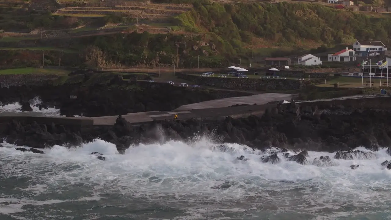 Big waves crashing into rocky coastline of Azores island during sunset