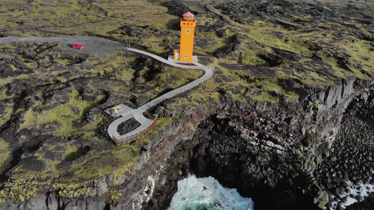 Aerial of Svörtuloft Lighthouse at a rocky coast with cliffs in Iceland