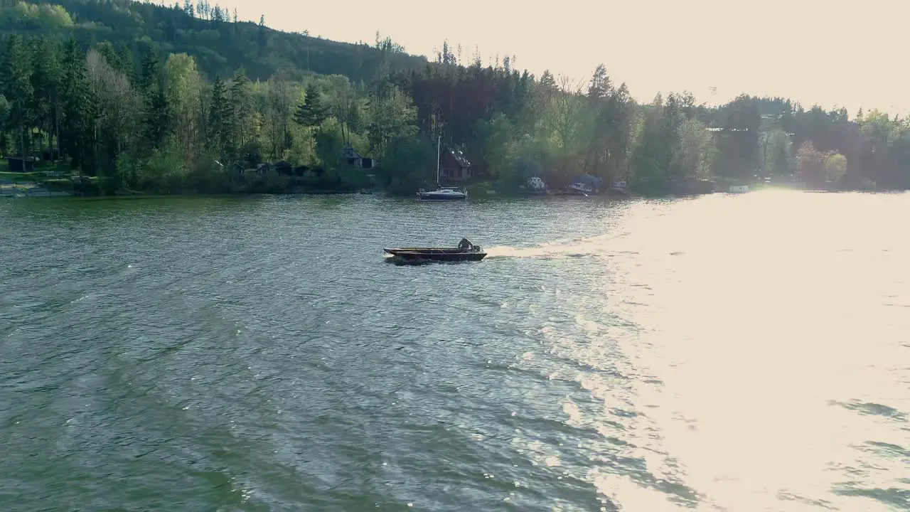 Boat navigating rough waters of Oravska Priehrada lake Namestovo Slovakia aerial