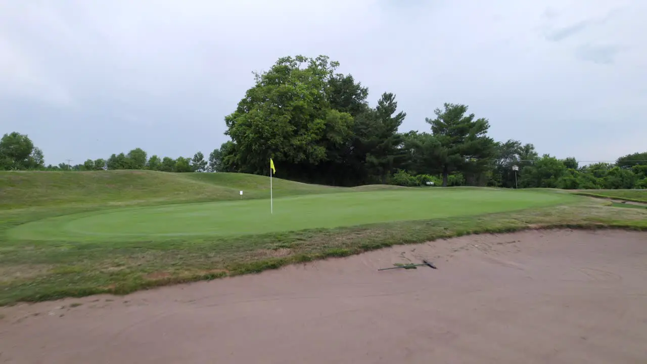 golf hole lake bunker fly by drone view