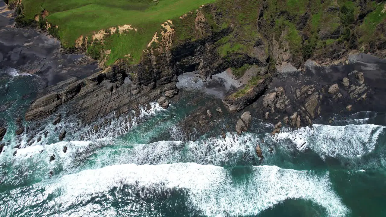 Waves crashing on rocky New Zealand shoreline