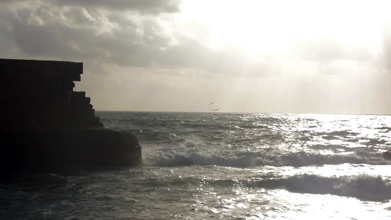 Wavy sea and ancient walls of Acre city Israel