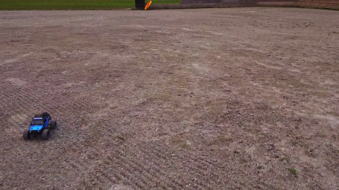 A miniature 4WD electric truck competes over rough terrain guided remotely by a radio-controlled engine