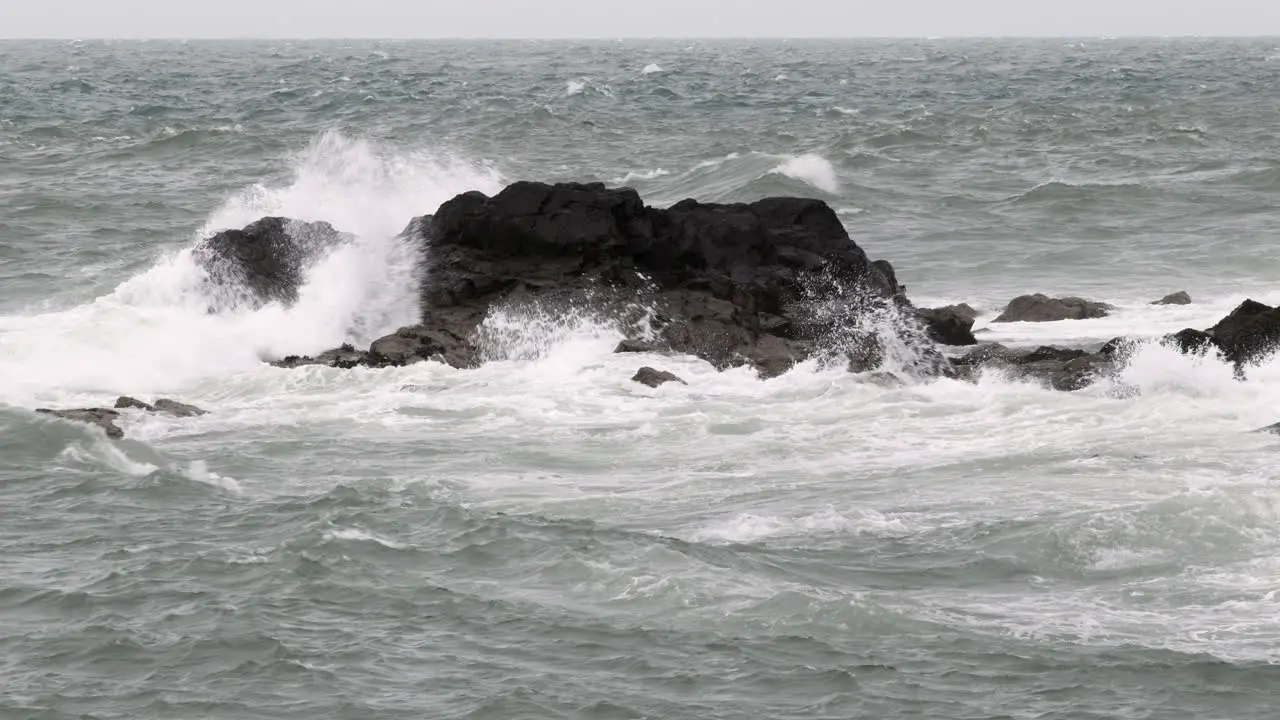 Waves crashing on rocks on the West Coast of Scotland in the village of Port Patrick