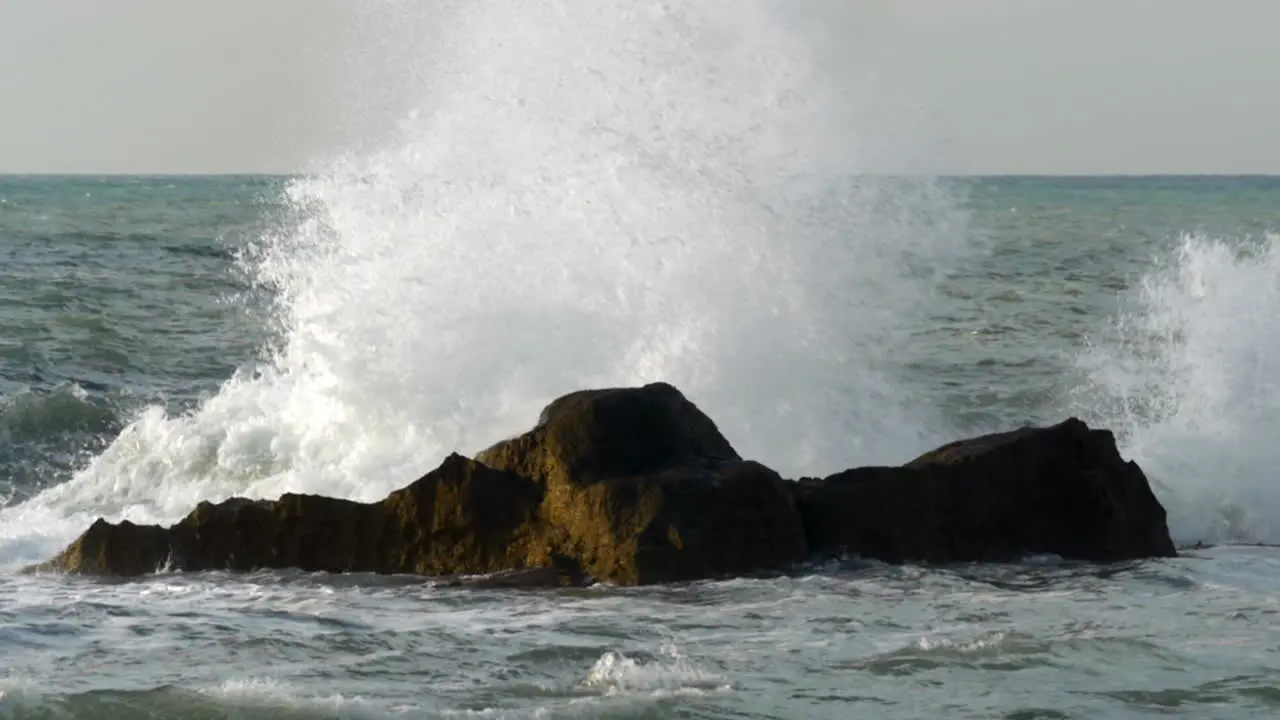 Rough sea crushing the rocks with high splashes