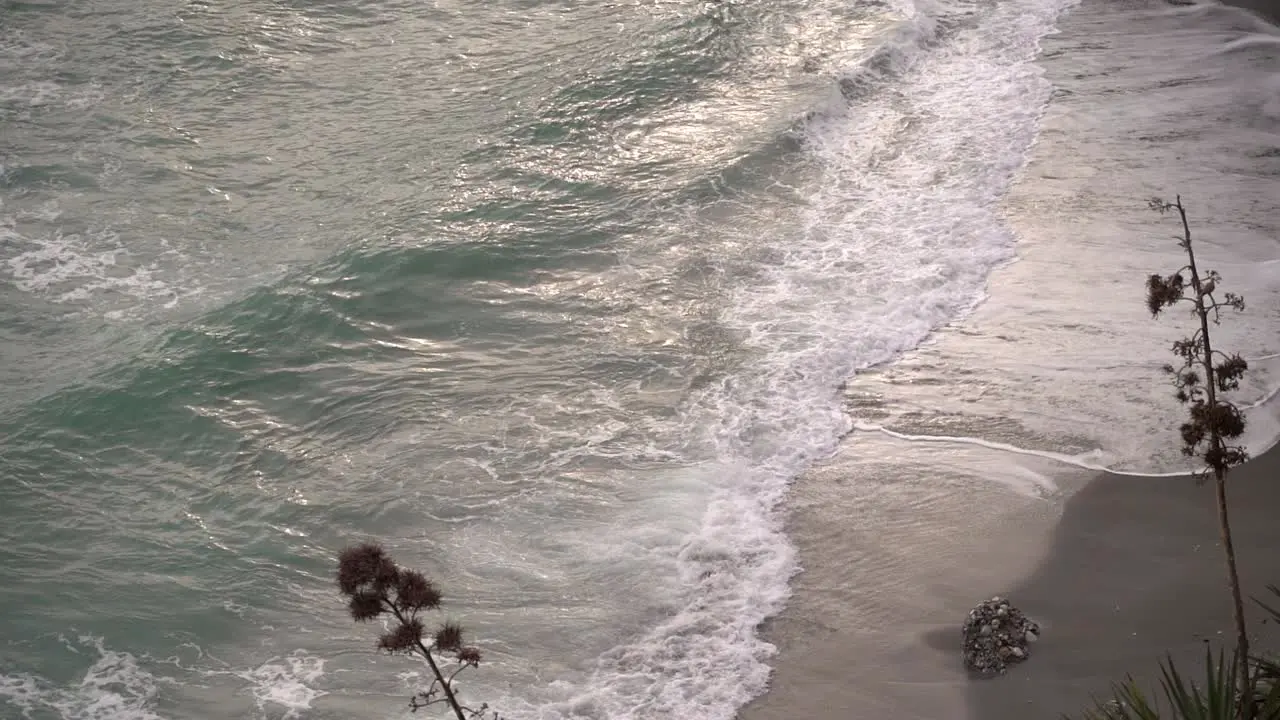 Scenic view of waves crashing on beach in slow motion