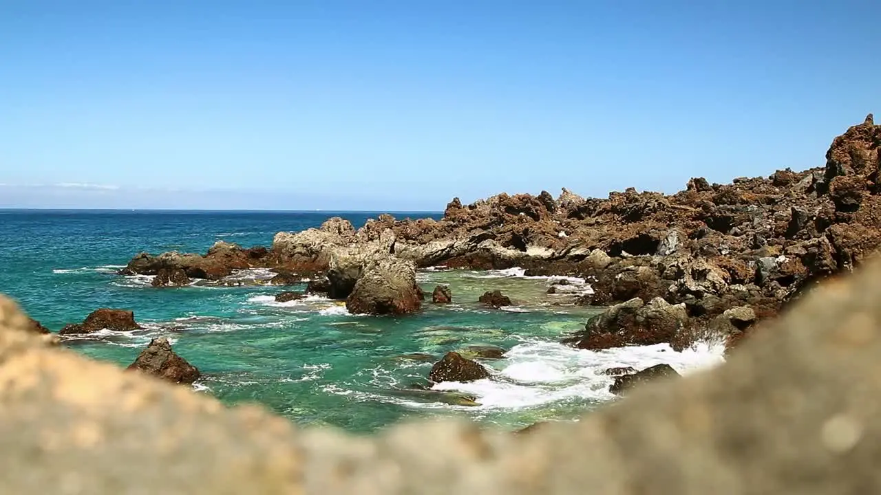 Rocky volcanic sea coast of Tenerife on a hot summer day