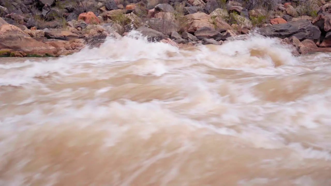 Fast white water rapids in a river close up