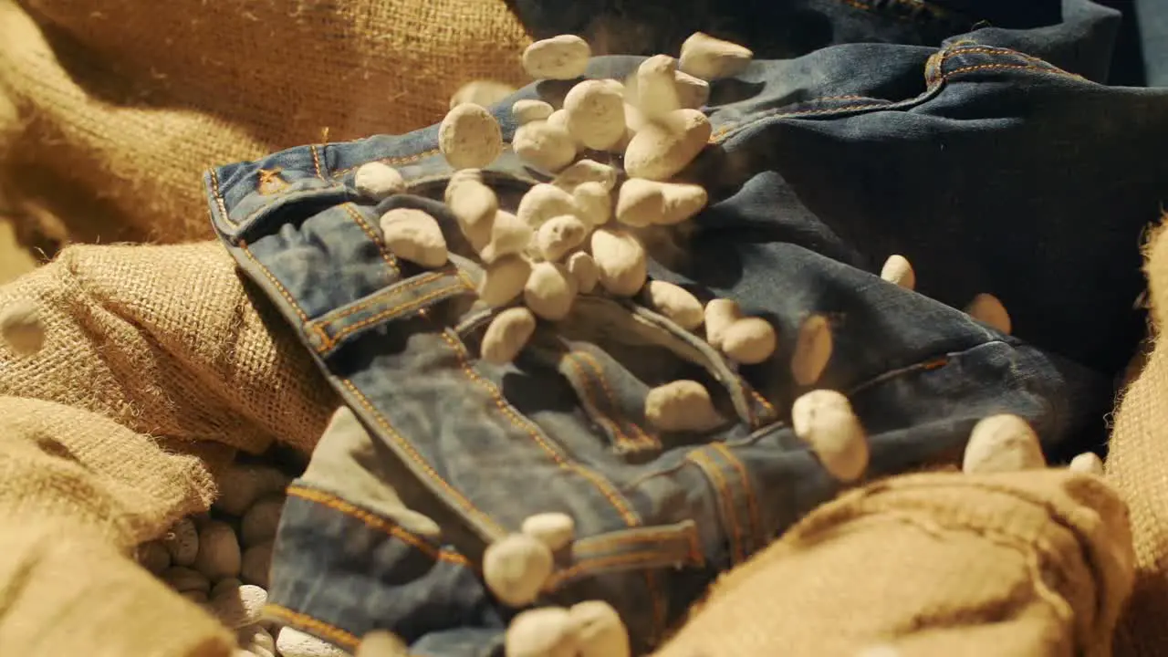 Slow motion stones fall on jeans