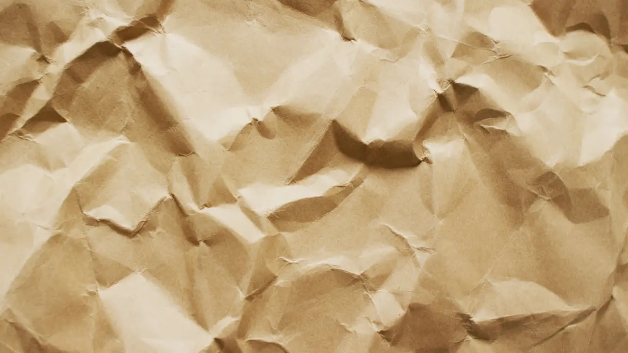 Video of close up of crumpled brown paper texture background