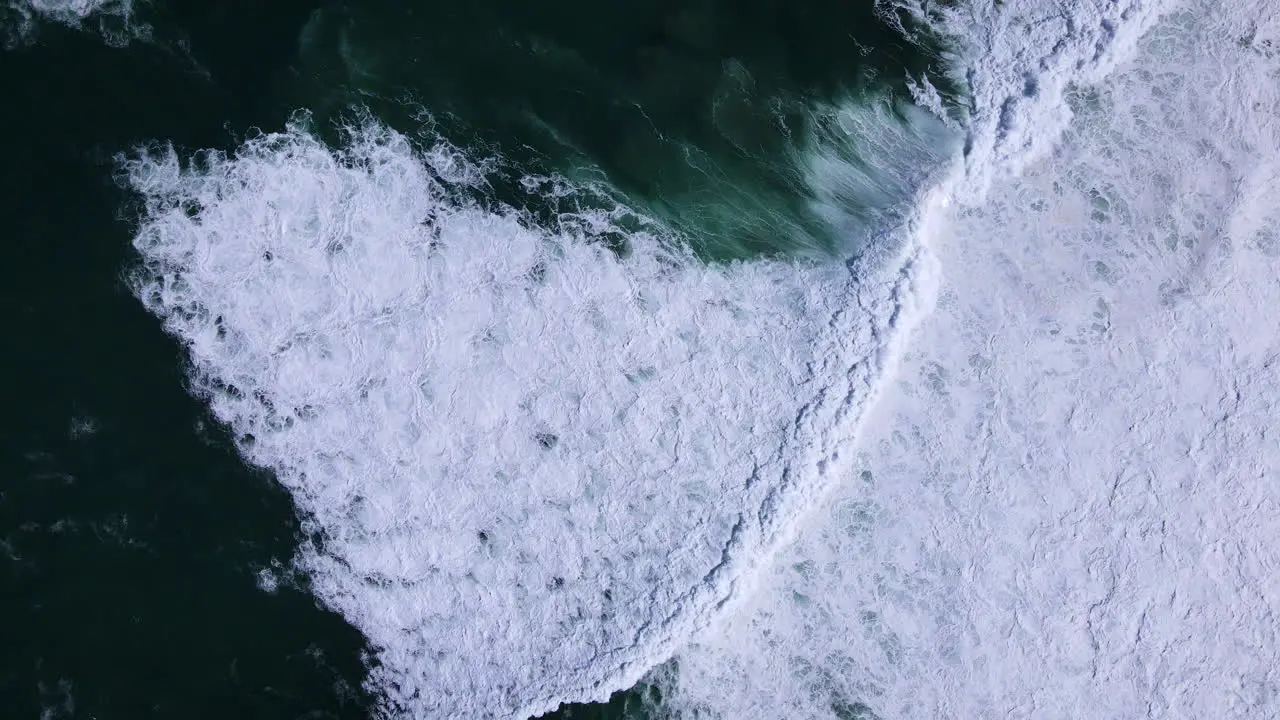 Massive Atlantic swells crash onto coastline whitewash in shallows